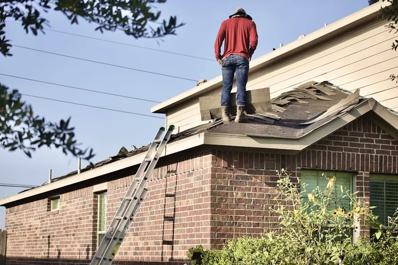 Professional roofer working on a residential roof in West Adams